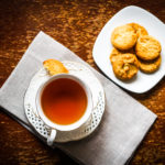 Tea with cookies on wooden background